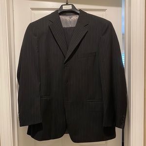 Men’s black suit with white pinstripes